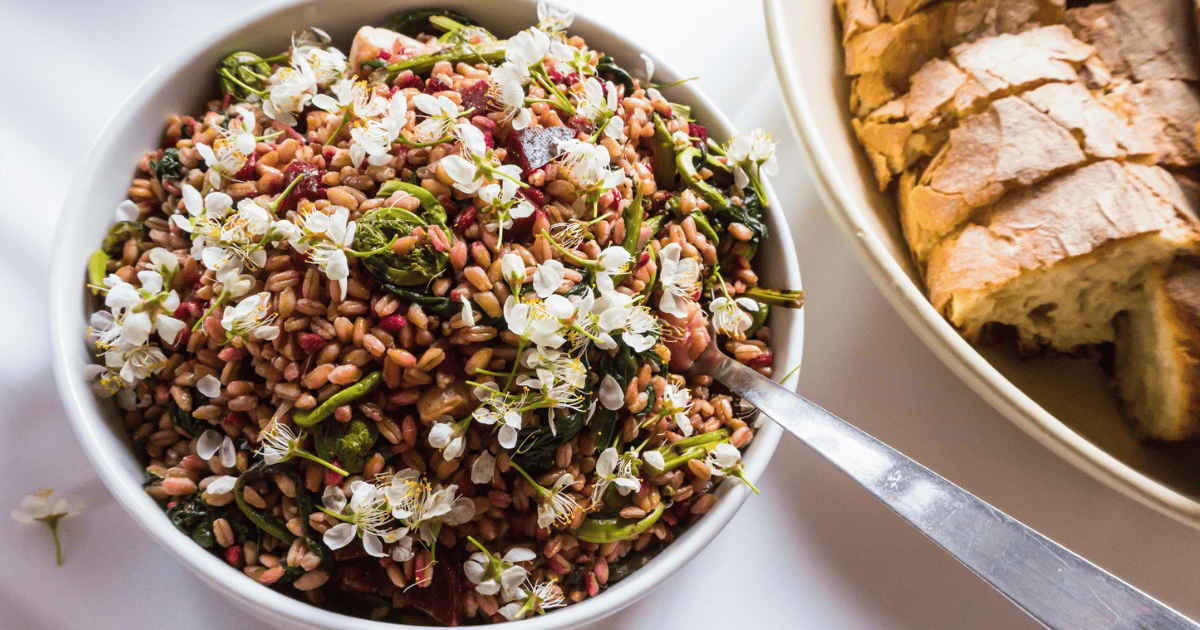 Bowl of farm fresh salad with a loaf of bread